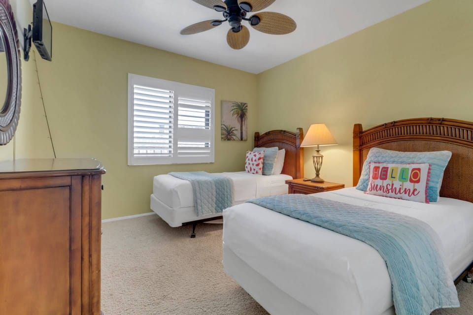 The 2nd guest room at the front of the condo has a pair of twin beds made for your arrival with provided linens.