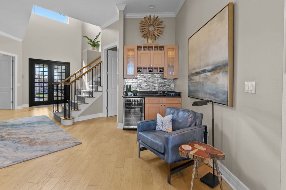 Unwind in plush comfort with a cozy seating area and a stylish wet bar—perfect for relaxing and entertaining.