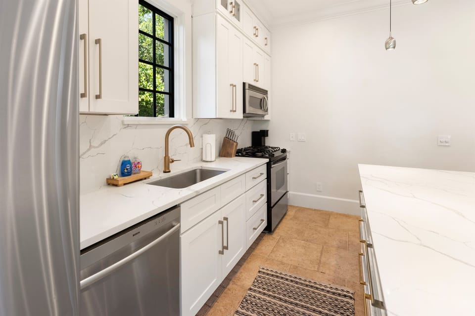 Your sleek modern kitchen features marble countertops, stainless steel appliances, and everything you need to create memorable meals during your stay.