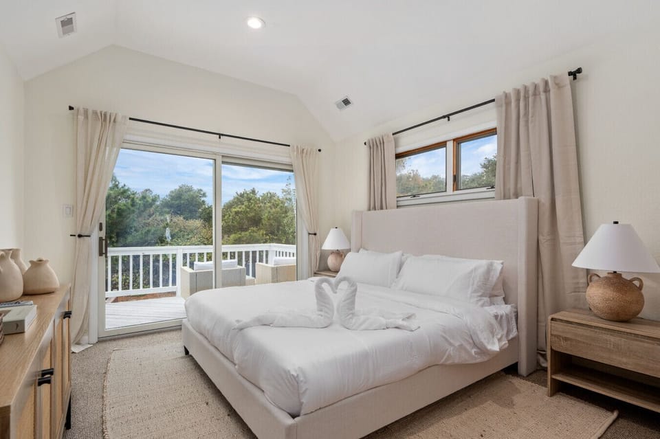 Airy bedroom w/ crisp whites, soft light & a calm, restful feel.