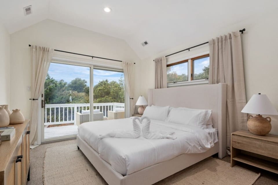 Airy bedroom w/ crisp whites, soft light & a calm, restful feel.