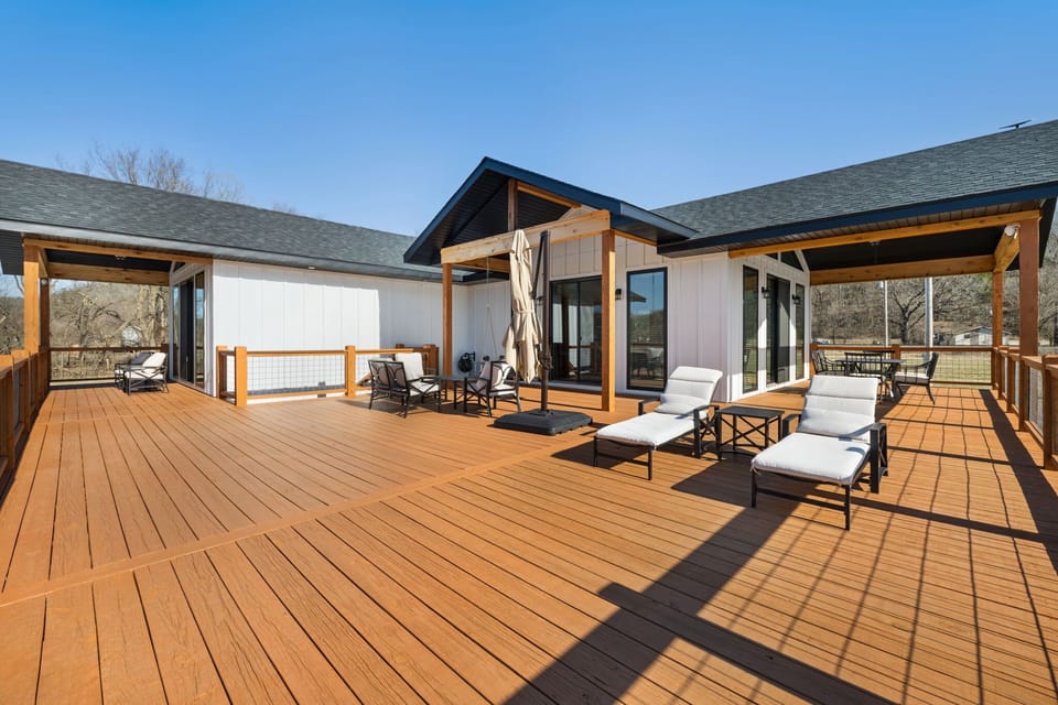 Take in the peaceful, natural scenery from the HUGE lifted porch with lounge seating and a dining table.
