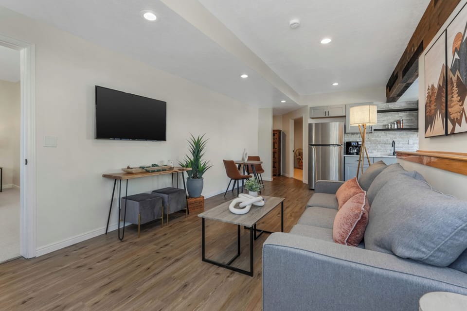 our spacious family room, comfy couch and 2 stools for additional seating 