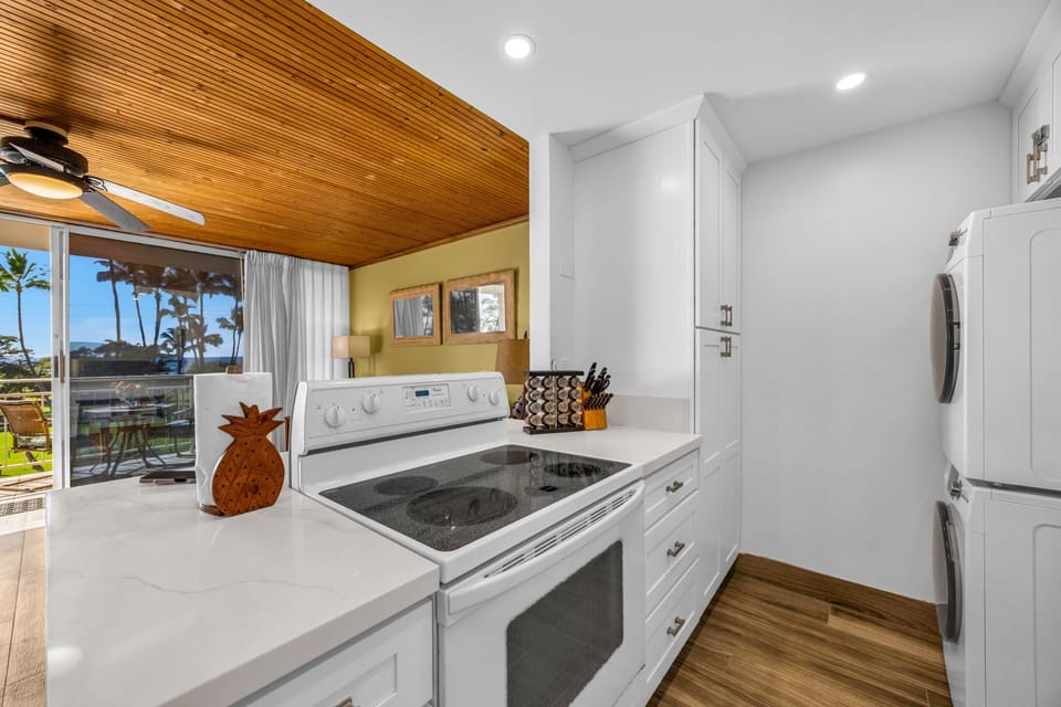 Beautiful white kitchen features full appliances.