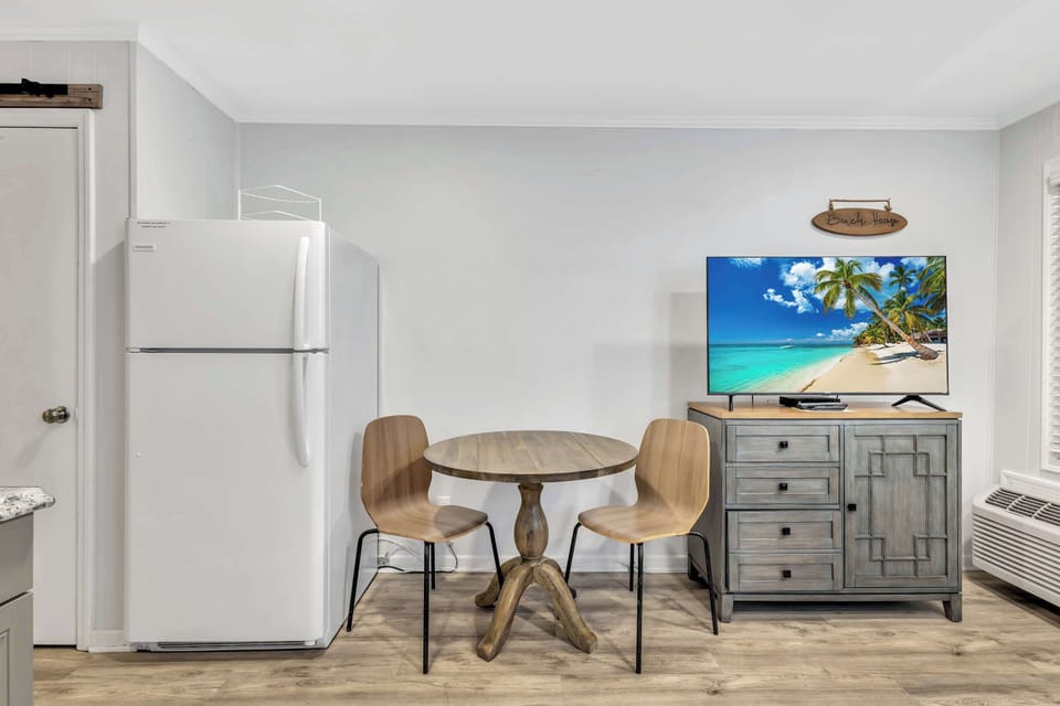 Gather around the small dining area, perfect for enjoying meals or planning your next island adventure.