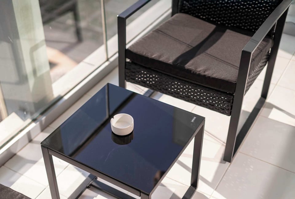 This minimalist seating area in Business Bay, Dubai near Burj Khalifa, Downtown and DIFC includes a modern table and soft lighting, offering a quiet and relaxing space with a clean urban feel.