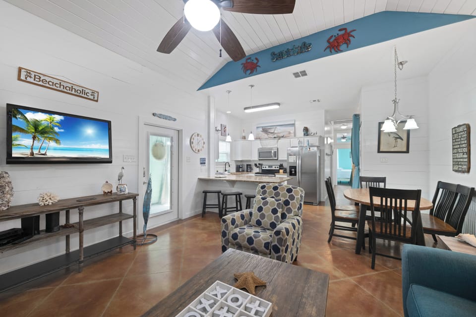 Enjoy the Mounted TV with Views from Living, Dining, and Kitchen Areas