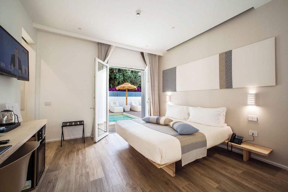 Deluxe Double or Twin Room, Pool View | In-room safe, desk, laptop workspace, blackout drapes