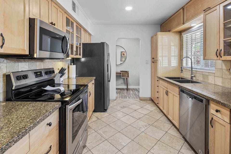 Fully equipped kitchen with stainless steel appliances and plenty of counter space for cooking.