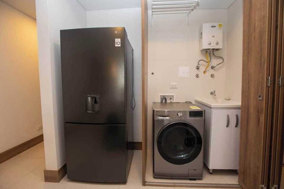 Big fridge with freezer below and 2-in-1 washer and dryer at your disposal. 
