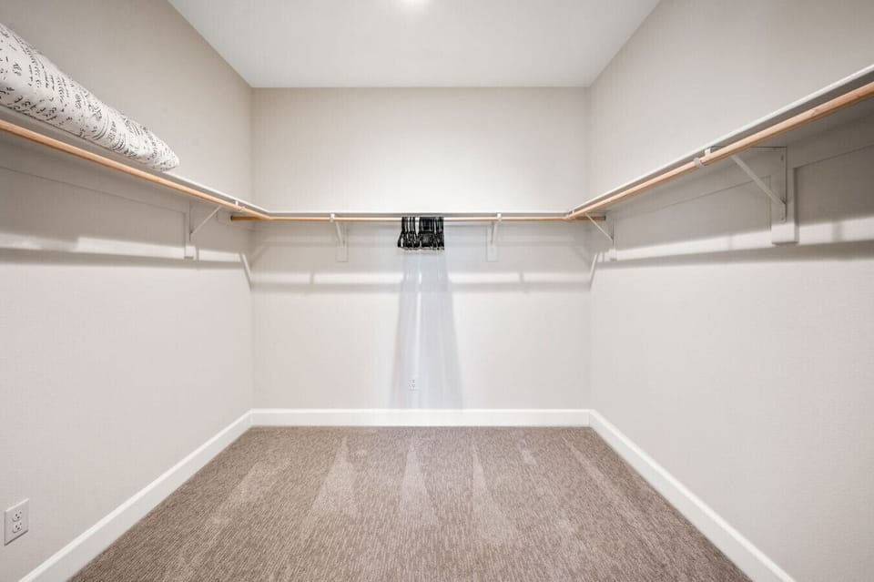 Spacious walk-in closet w/ built-in shelving & ample room to organize your wardrobe