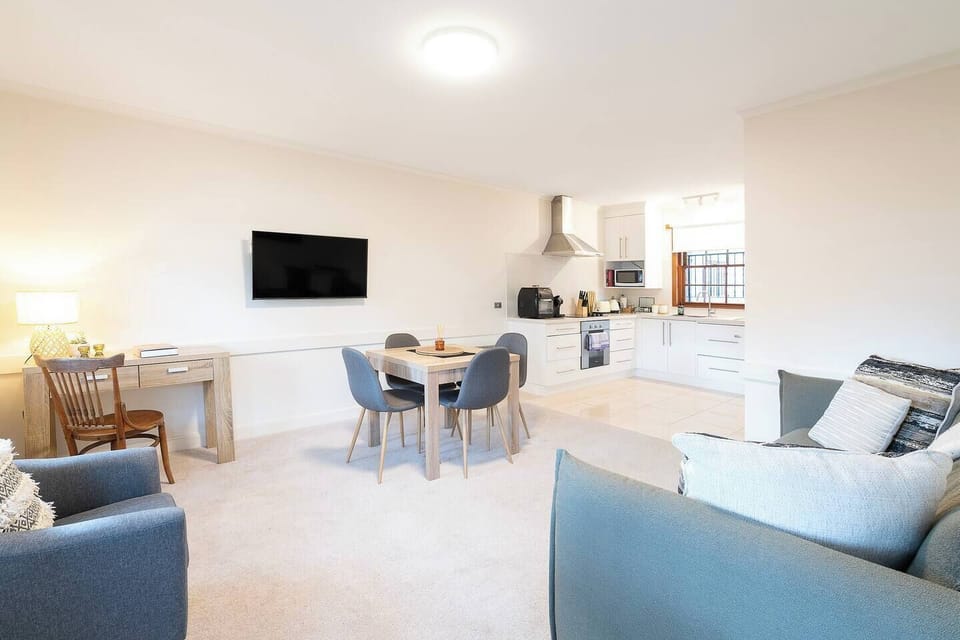 Move easily between living, dining and kitchen areas in the open-plan layout, enhanced by natural light throughout.