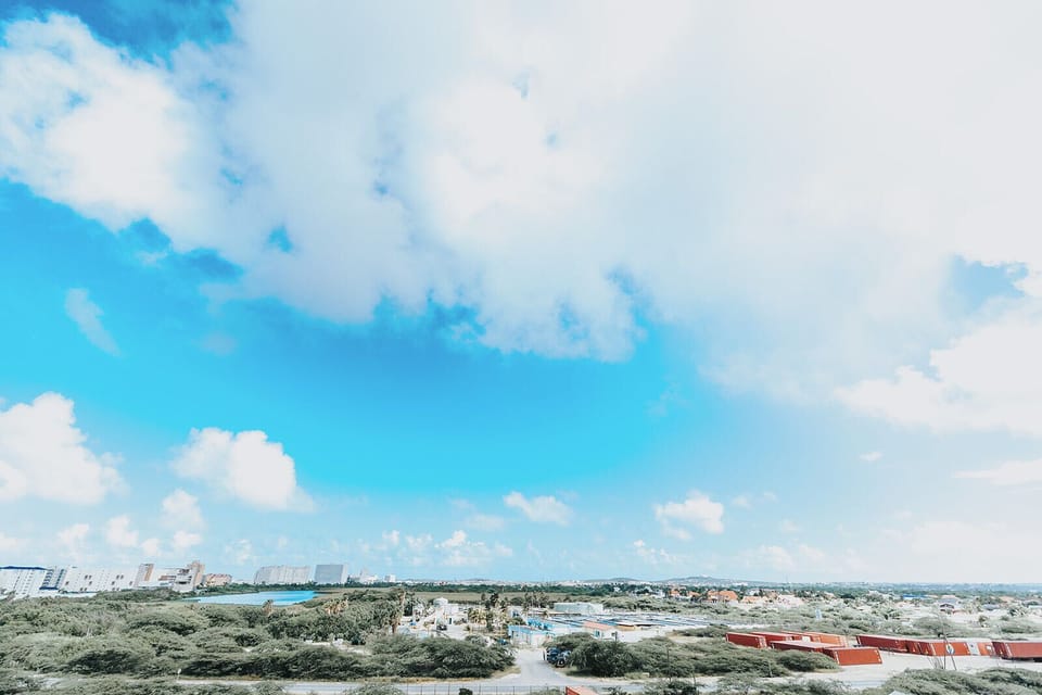 Aerial view capturing the property's coastal setting amid natural island vegetation and nearby beach access.