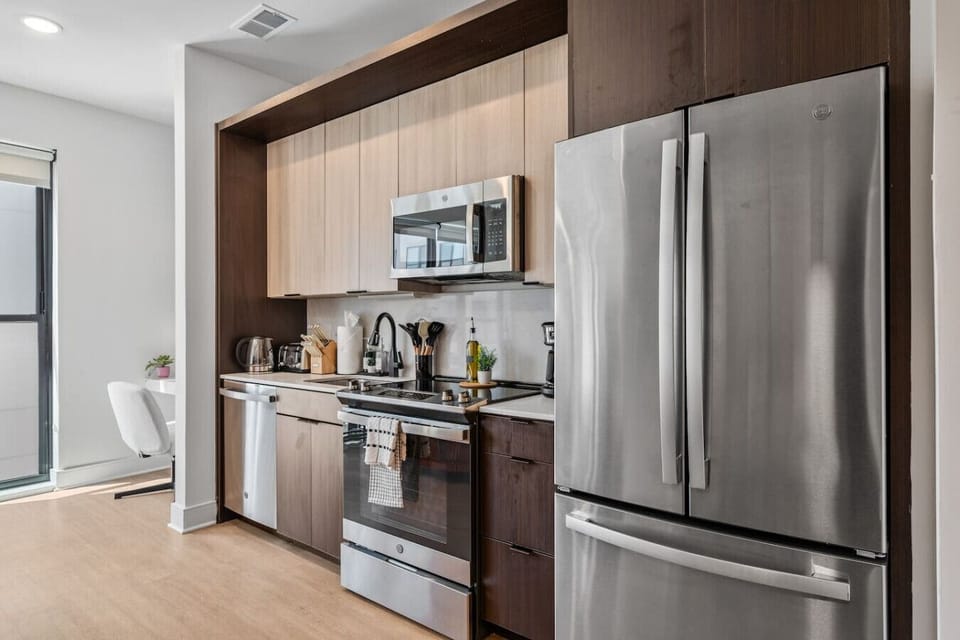 Designer kitchen with sleek two-tone cabinets and stainless steel appliances 🍴