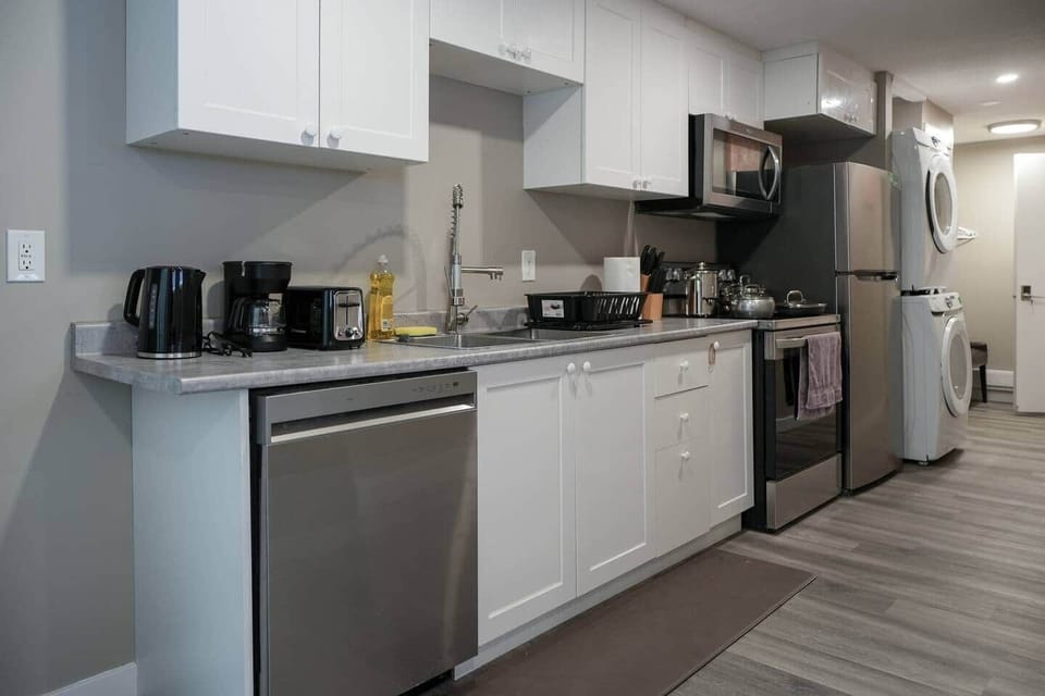 Stove, dishwasher, microwave, toaster, coffee pot, blender (check drawer), water heater, pots and pans, cutlery, cups, plates, washer and dryer.
