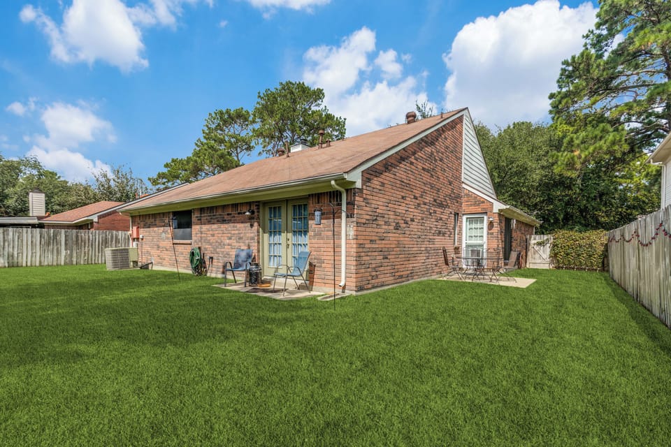 Privacy fenced back yard, garden swing, 2 patios, separate main suite access. 