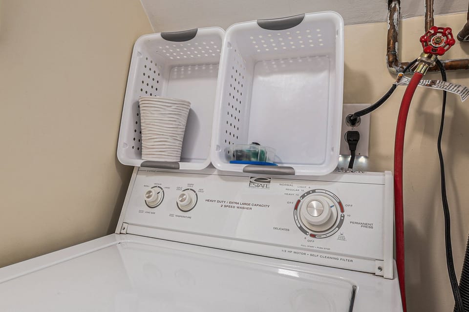 Main laundry room with washer[]dryer and laundry tub