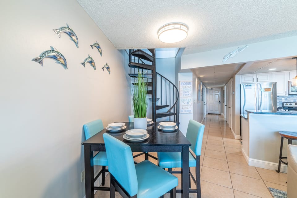 Walk up the spiral staircase to the penthouse loft area and extended deck