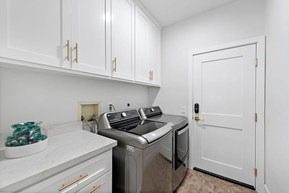 Laundry room with ample storage cabinets.