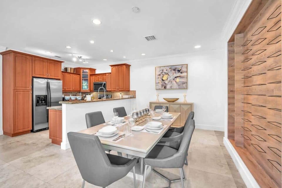 Dine in style with a sleek table, modern seating, and an open flow to the kitchen.
