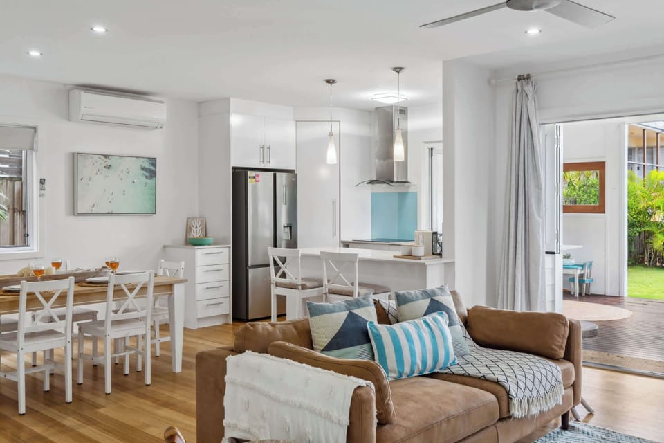 Stylish open plan living room with timber floors and natural light