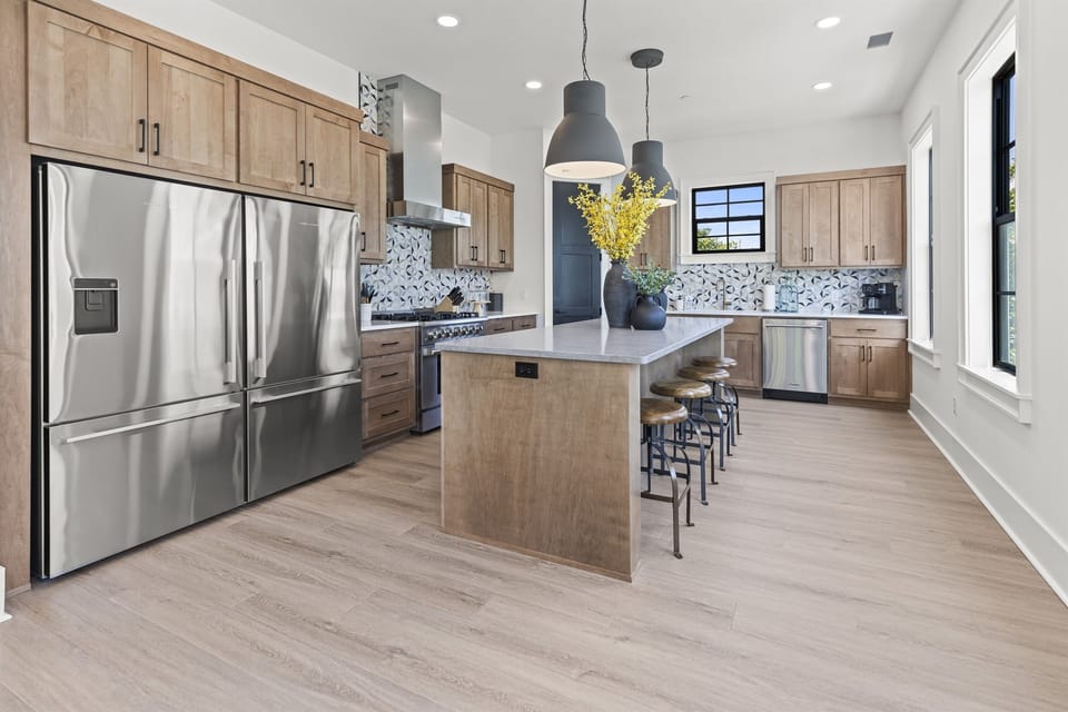 Your gourmet kitchen awaits with gleaming countertops, premium appliances, and a spacious island perfect for morning coffee or culinary adventures.