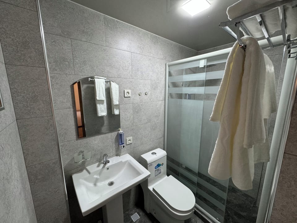 Classic Double Room, Courtyard View | Bathroom | Hair dryer, slippers, towels, soap