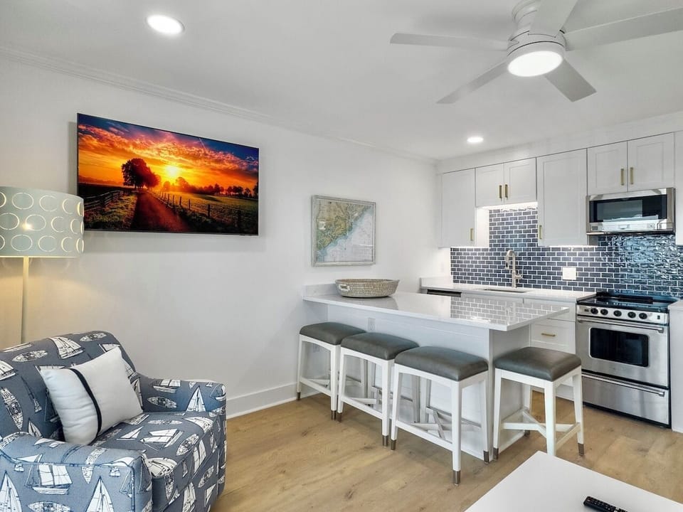 Kitchen with White Quartz Island with Seating for 4 | IOP Escapes The Admiral | Sea Cabins 307A | Top Floor Luxury Oceanfront Condo