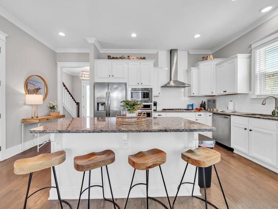 Your spacious kitchen features granite countertops, stainless steel appliances, and a breakfast bar where you'll love gathering for morning coffee.