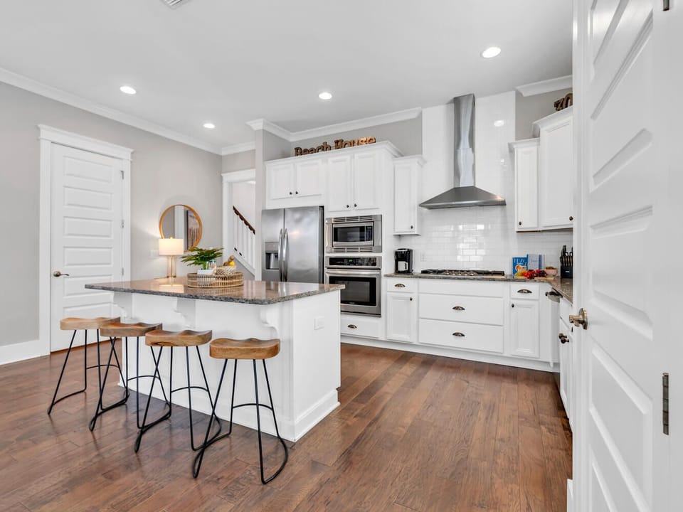 Your gourmet kitchen awaits with gleaming granite counters, stainless steel appliances, and a breakfast island perfect for morning coffee or evening conversations.