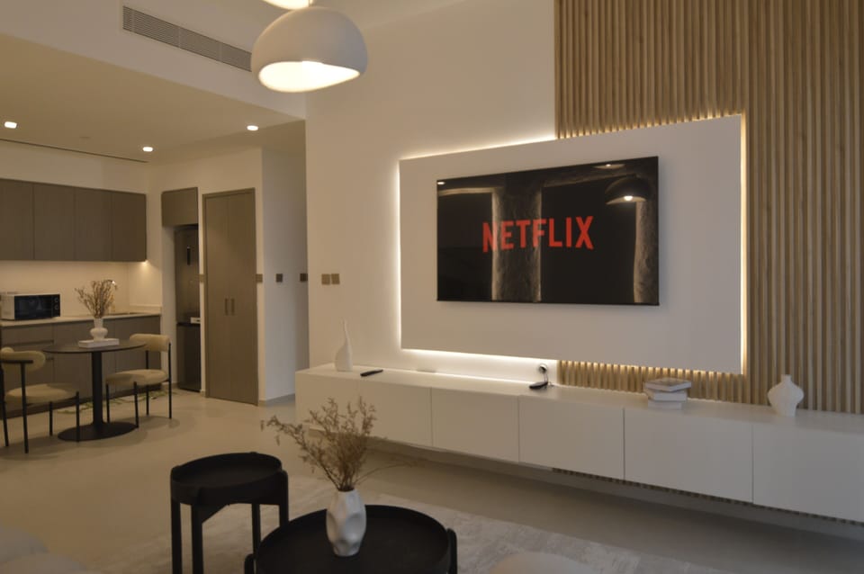 Luxury Apartment, Balcony, City View | Living area | 65-inch Smart TV with digital channels, books