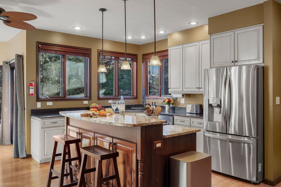 Large fully stocked kitchen with Gas range stove, two ovens and center island.