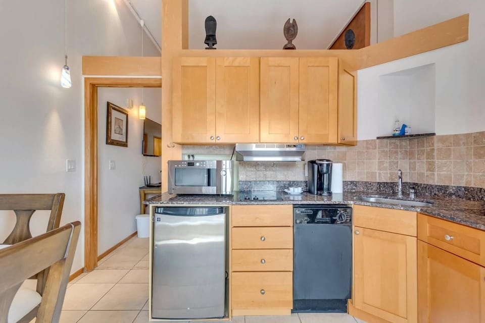 Enjoy the convenience of our kitchen, featuring a Refrigerator, Microwave, Cook Top, Coffee Maker, Dishware and Utensils