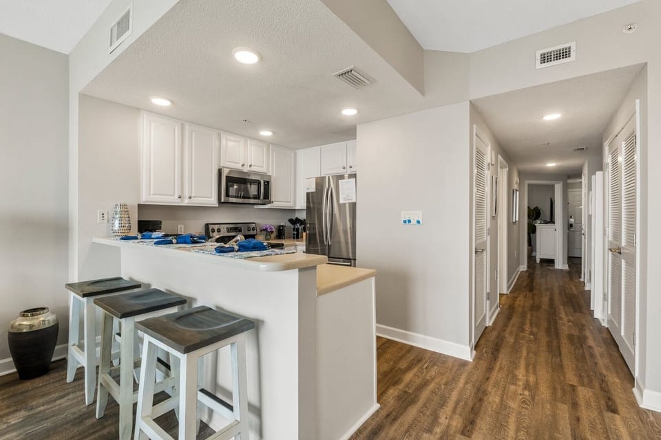 Well-equipped kitchen with modern appliances and breakfast bar — perfect for beachside breakfasts and seafood dinners.