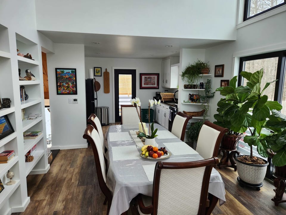 Interior dining space, view of kitchen.  A few fiddle leaf figs.