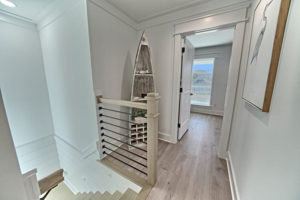 A beautifully styled landing with warm wood tones and breezy beach-inspired decor.