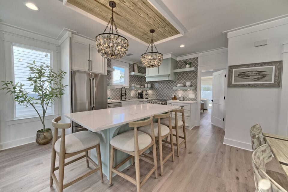 Chic lighting, sleek countertops, and open shelving make this kitchen a true standout.