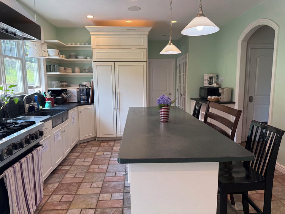 Full Kitchen for cooking and eating meals, with bar stools at the counter 