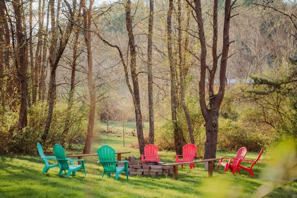 Outdoor Fire Pit: Gather around vibrant chairs for stories and s'mores in nature's embrace!