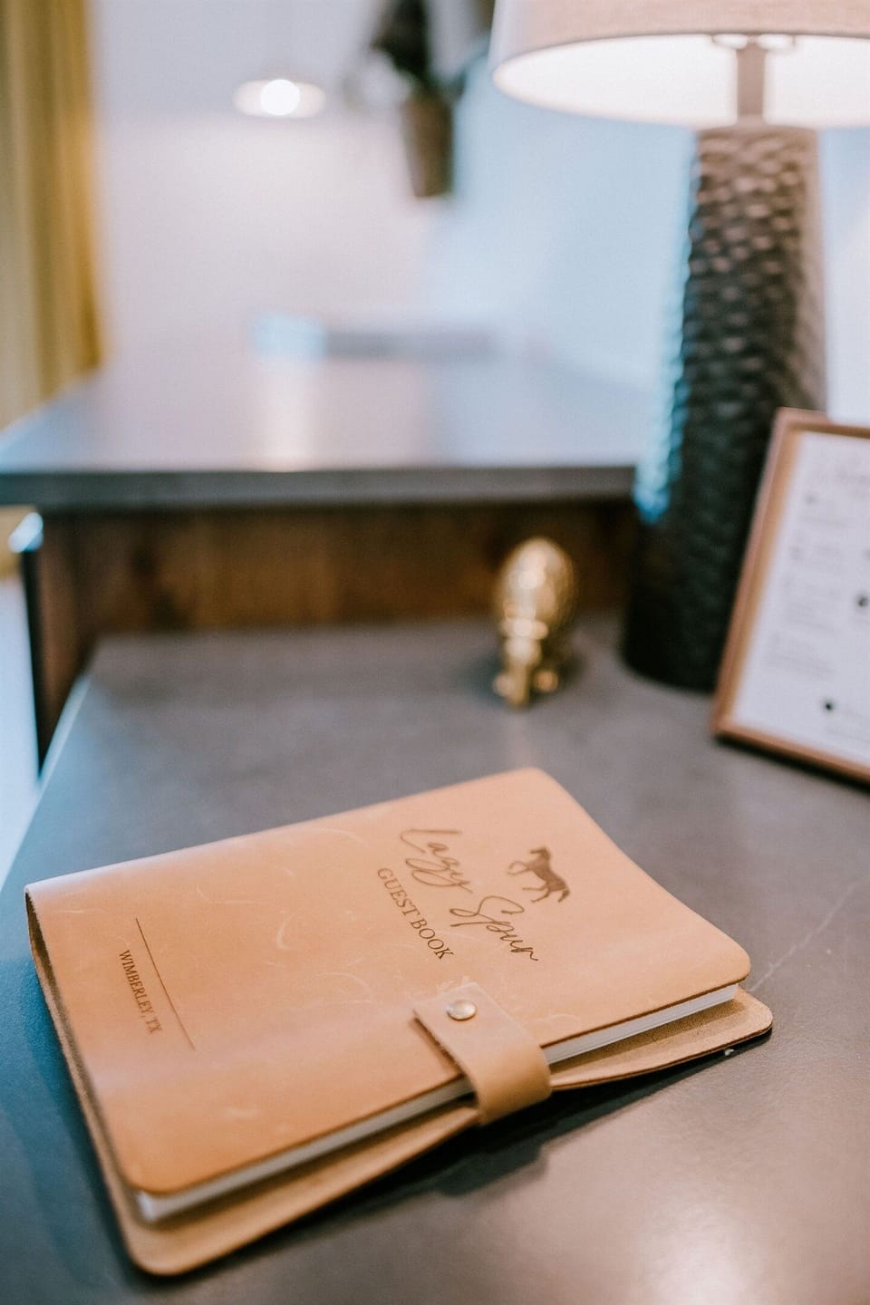 The Lazy Spur Suite guestbook — leave a note for the next traveler in a leather-bound keepsake at Gaines Ranch on the Square.