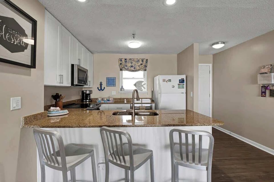 An impeccably stocked kitchen awaits, equipped with everything you need for a delightful culinary experience.