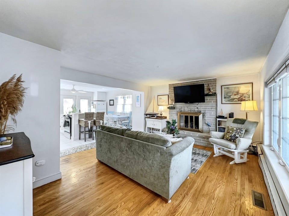 Spacious open-concept living area with a cozy fireplace, perfect for unwinding after a day by the river.