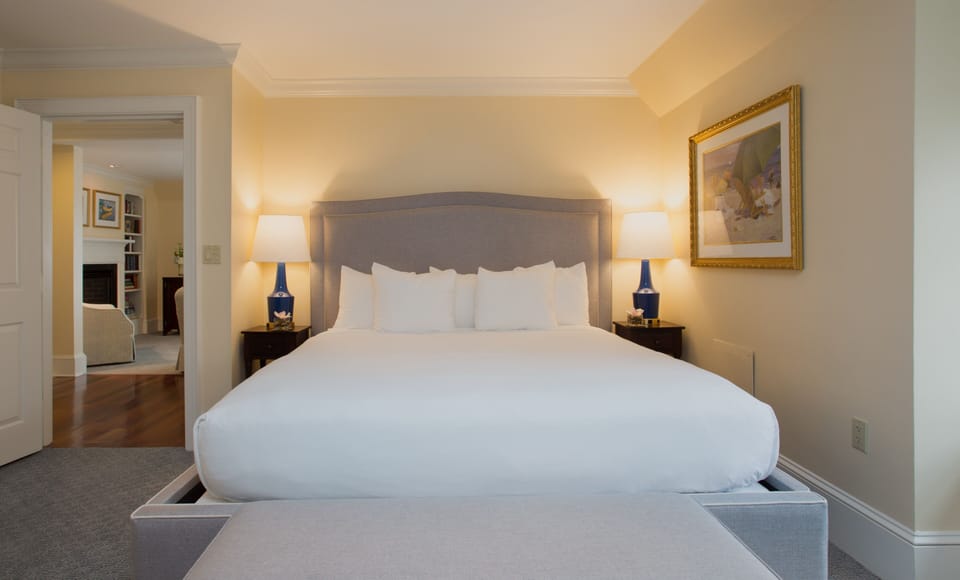 Plush bedding and warm lighting invite you into a peaceful retreat for a restful night’s sleep.