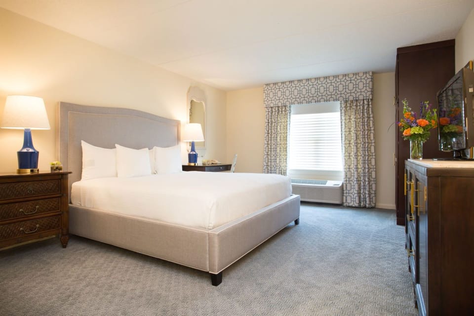 A serene and inviting bedroom with plush bedding and warm lighting for ultimate relaxation.