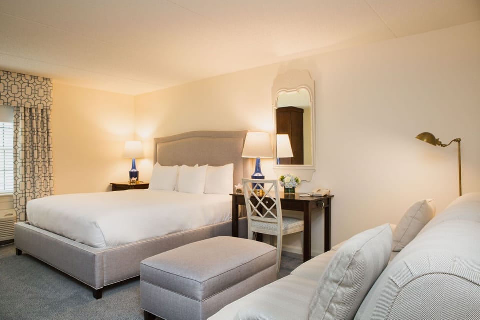 A beautifully designed bedroom with plush seating and soft lighting for a cozy, restful retreat.