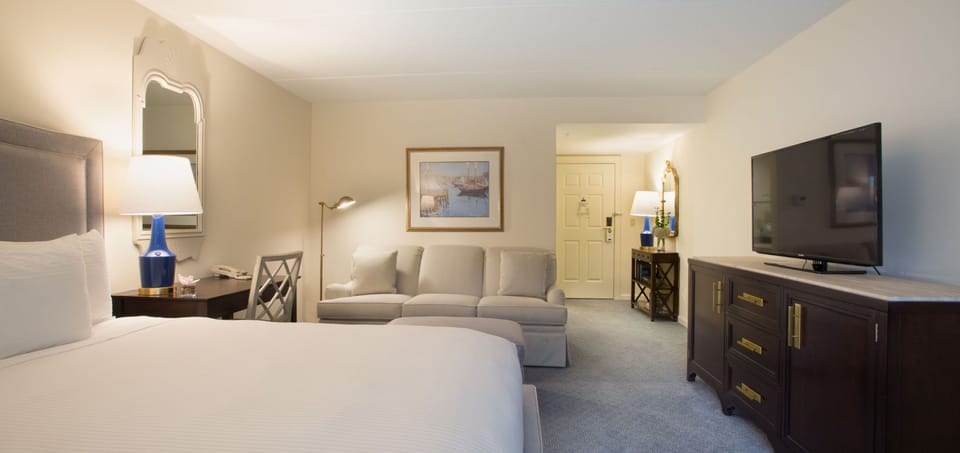 A spacious and elegantly designed bedroom with plush seating for ultimate relaxation.