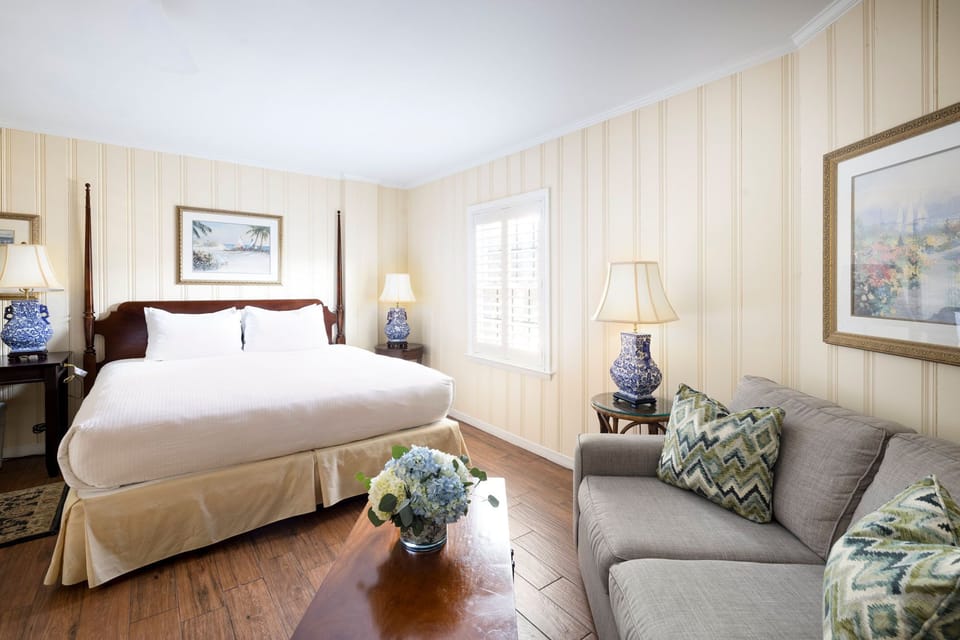 A cozy and stylish suite featuring elegant decor and a comfortable seating area.