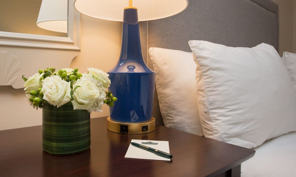 Thoughtful bedside details with soft lighting create a cozy and inviting atmosphere.