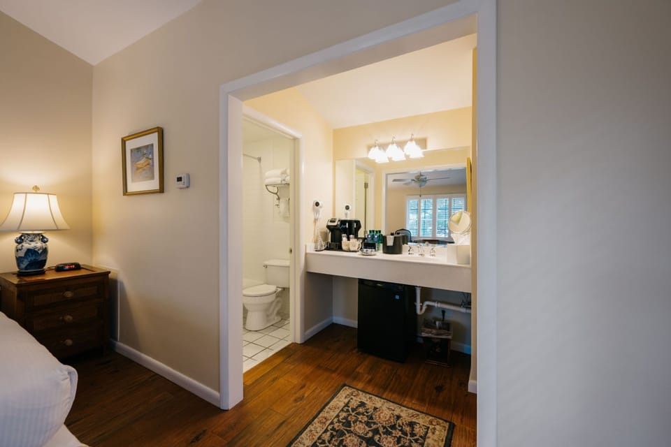 A thoughtfully designed space with seamless access to a well-appointed bathroom.