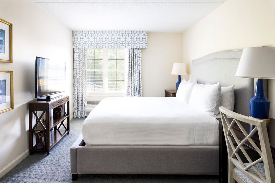 Serene bedroom featuring a luxurious bed, soft natural light, and stylish furnishings for restful nights.